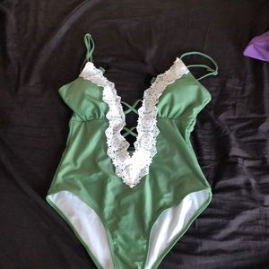 Green one piece bathing suit. NEVER WORN!